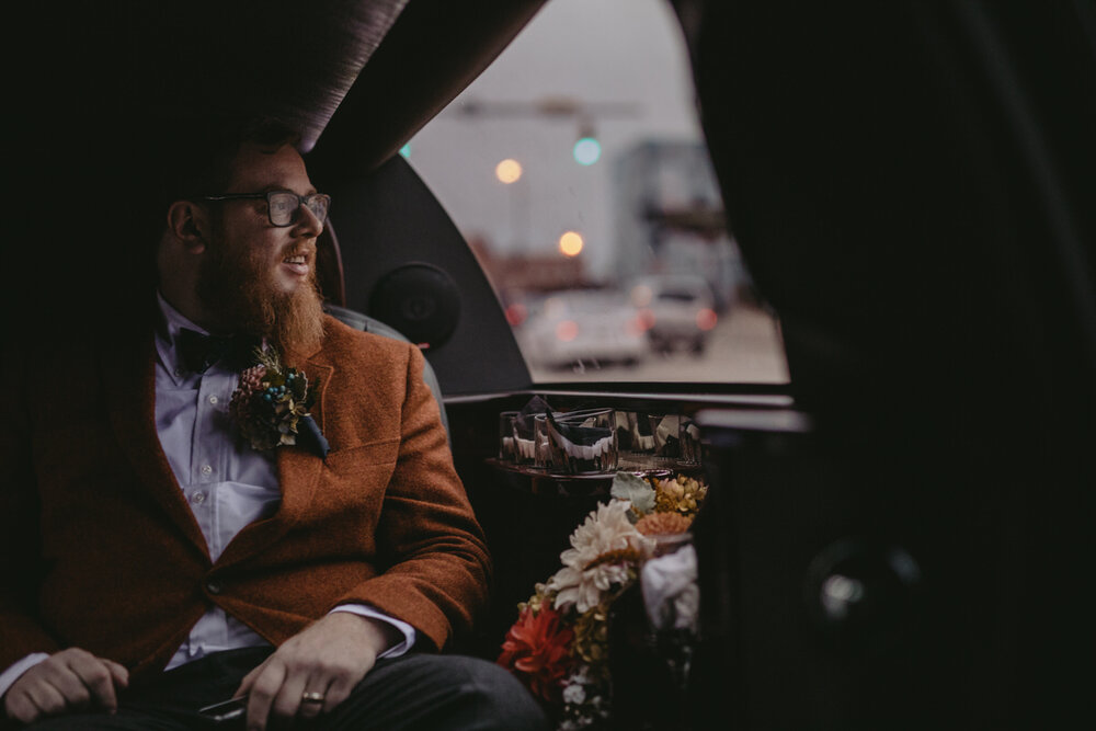 Groom in car to reception at Corradetti Glassblowing Studio Baltimore MD Carly Romeo