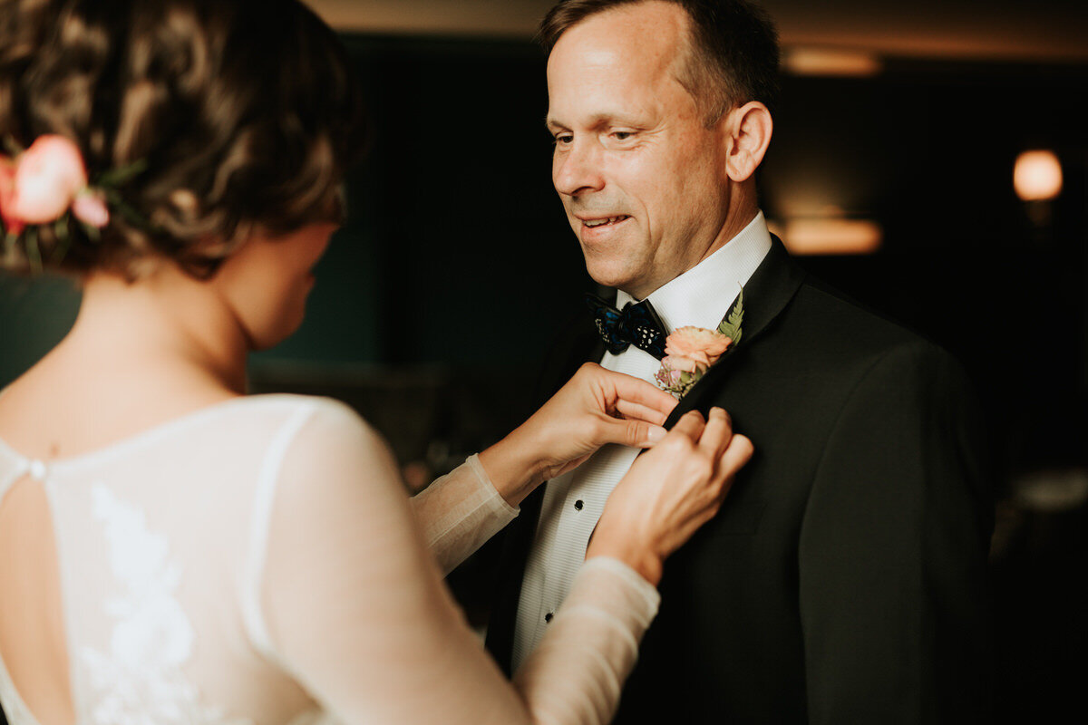 Bride pinning boutonniere to Dad's lapel in Richmond Virginia Carly Romeo + Co.