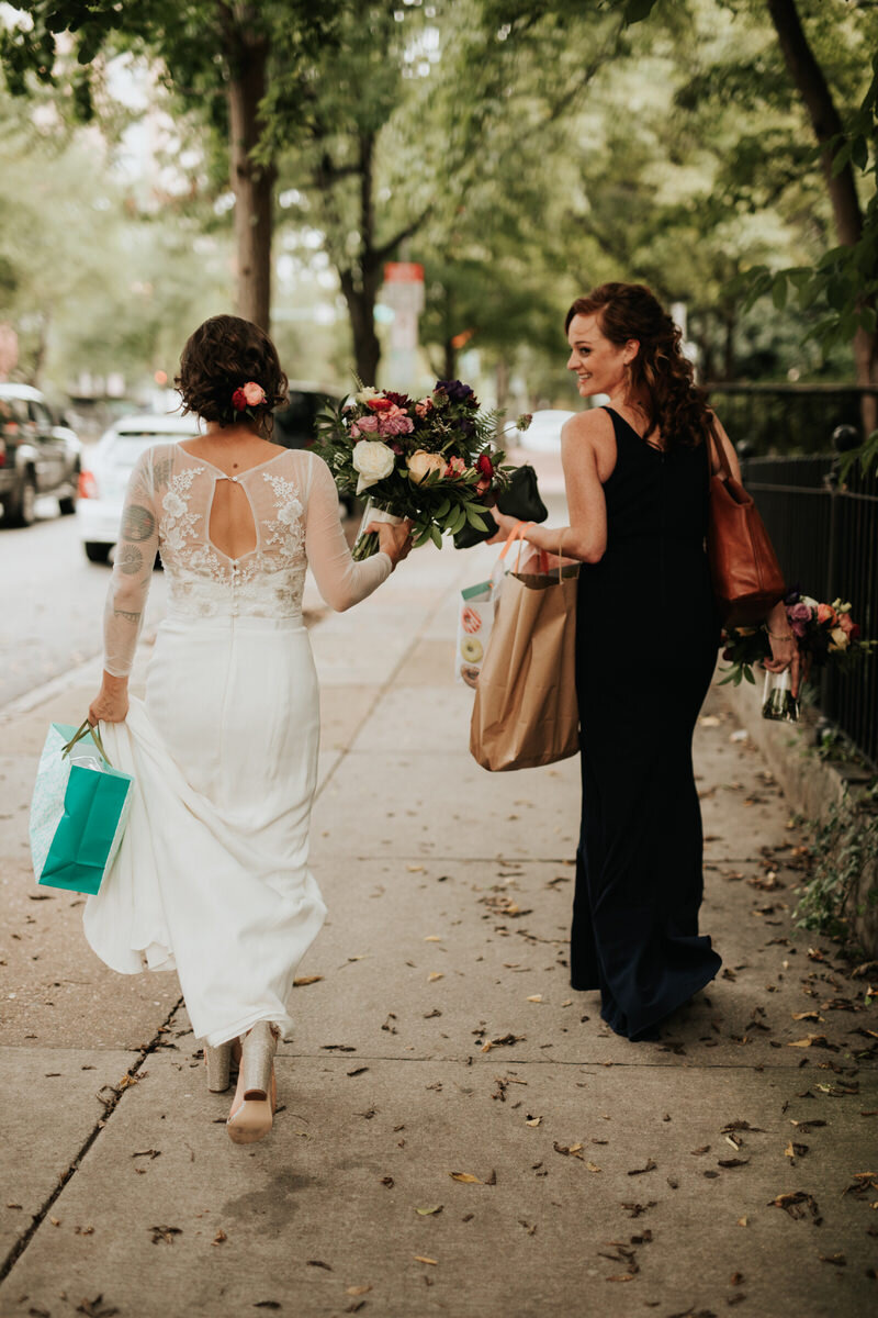 Bride and bridesmaid walking to Studio Two Three ceremony in Richmond VA Carly Romeo