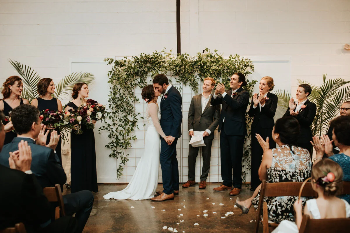 Newly weds kissing at wedding ceremony studio two three Richmond VA Carly Romeo &amp; Co.