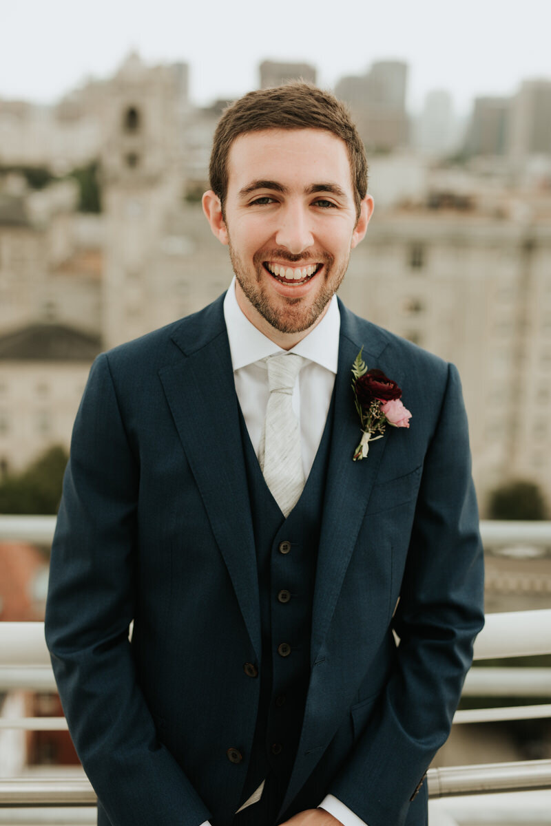 Groom laughing at Graduate Hotel roof top Richmond VA Carly Romeo photography