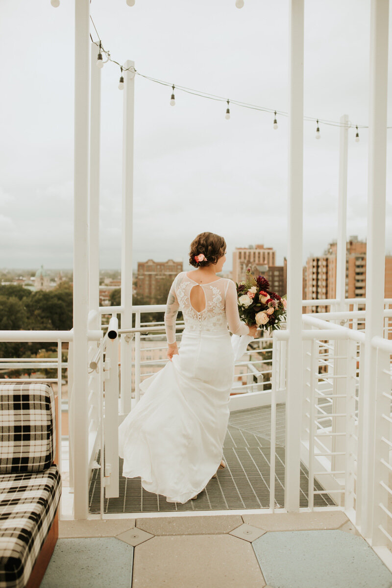 Bride walking with bouquet at Graduate Hotel Rooftop RVA Carly Romeo + Co