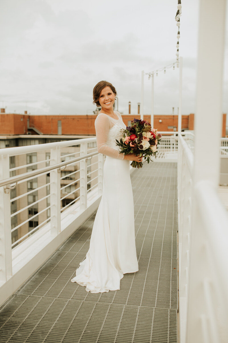 White bride with bouquet on rooftop at Graduate Hotel Richmond VA Carly Romeo + Co.