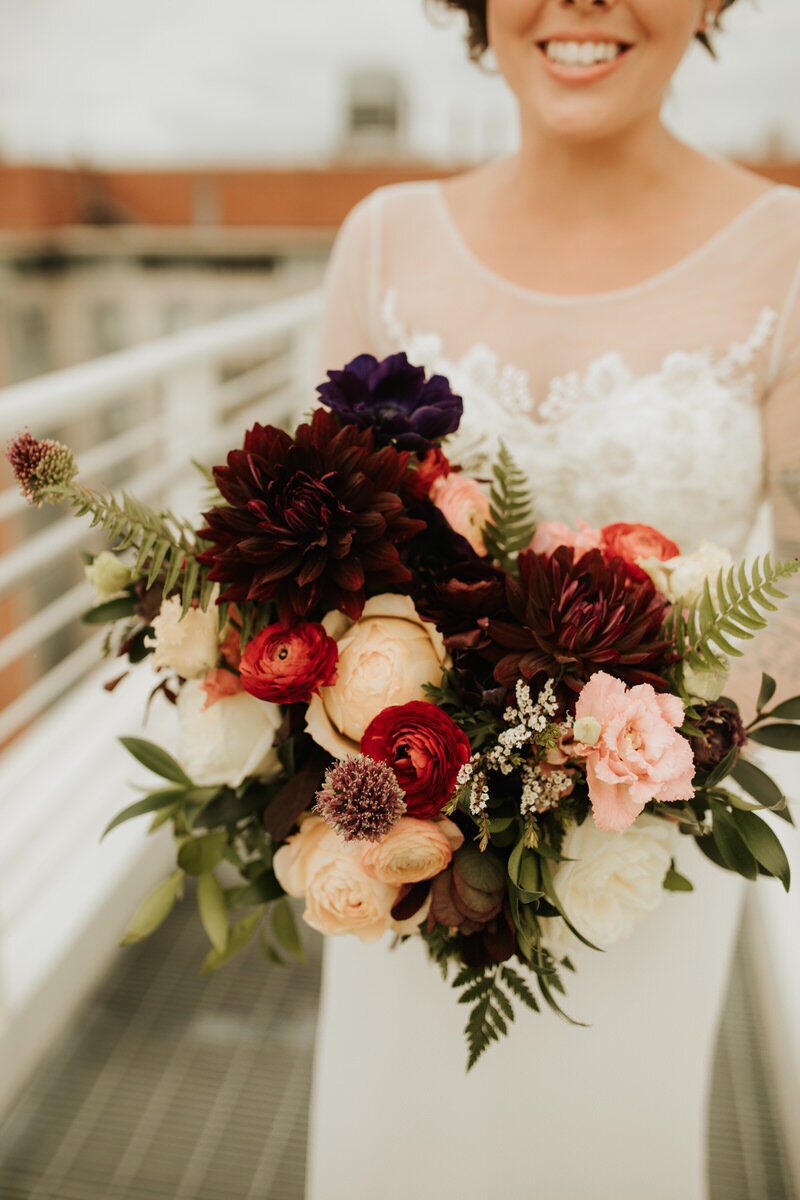 Bride with bouquet at Graduate Hotel roof top Richmond VA Carly Romeo photography