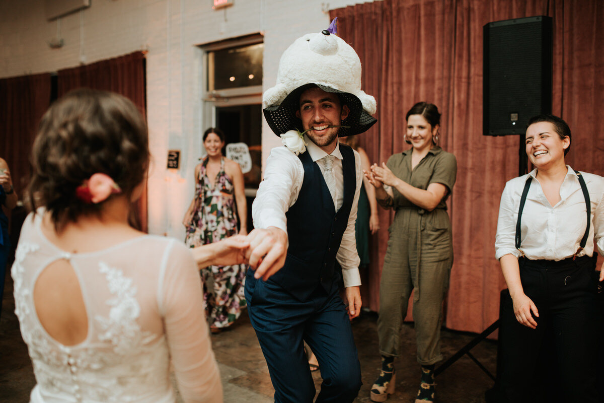 Groom with stuffed hat dancing with bride at Studio Two Three dance party reception RVA Carly Romeo