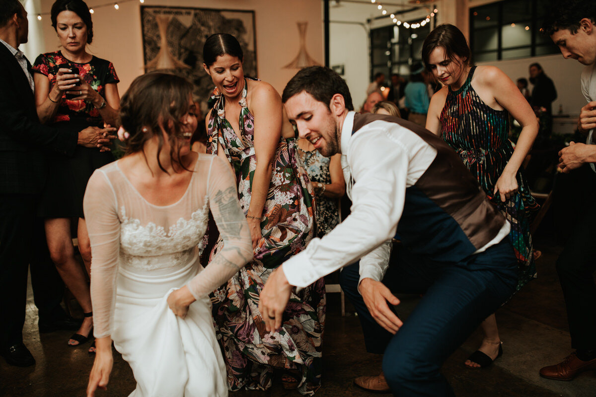 Newlywed couple dancing with friends and reception in Studio Two Three Richmond Virginia Carly Romeo photography