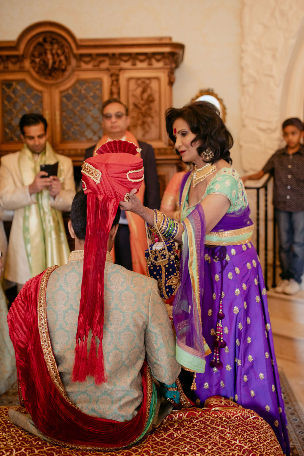 Mother of the groom performing Sehra Bandi turban ceremony at Dover Hall RVA Carly Romeo and Co.