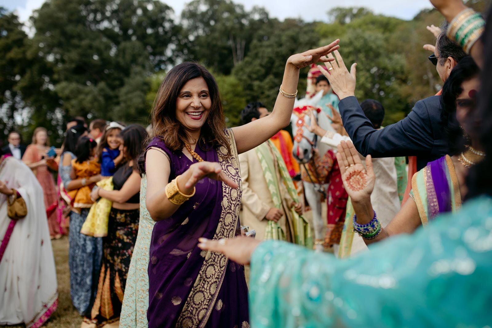 Family dancing at traditional indian Baraat ceremony at Dover Hall Richmond VA Carly Romeo photography