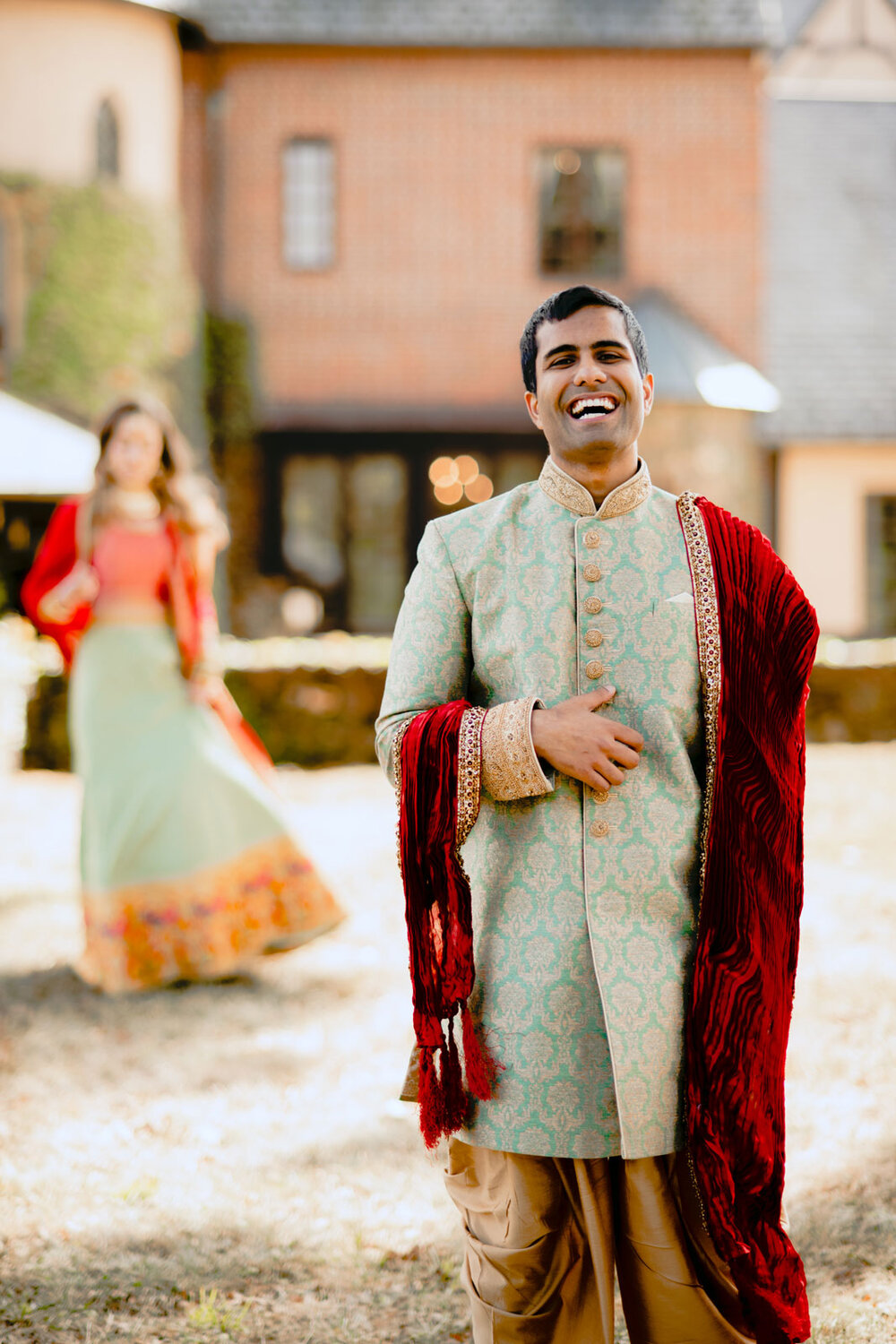 Indian Groom in traditional indian formal attire smiling before first look outside Dover Hall RVA Carly Romeo