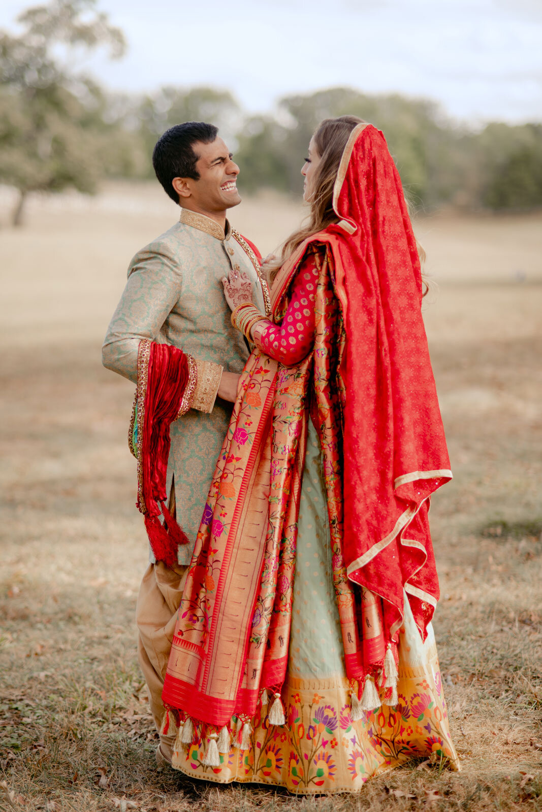 Mixed race couple smiling at first look in traditional indian formal wear at Dover Hall Richmond Carly Romeo + Co.