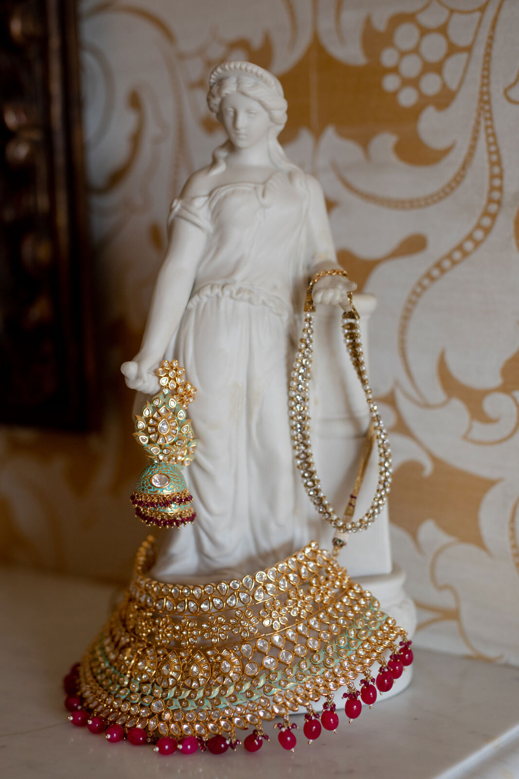 White figure sculpture holding indian wedding jewelry at Dover Hall RVA Carly Romeo
