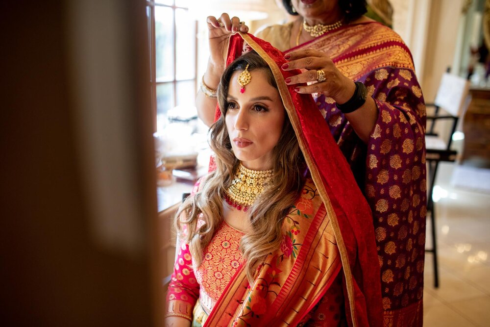 Bride putting on veil in traditional indian wedding dress at Dover Hall Richmond Virginia Carly Romeo