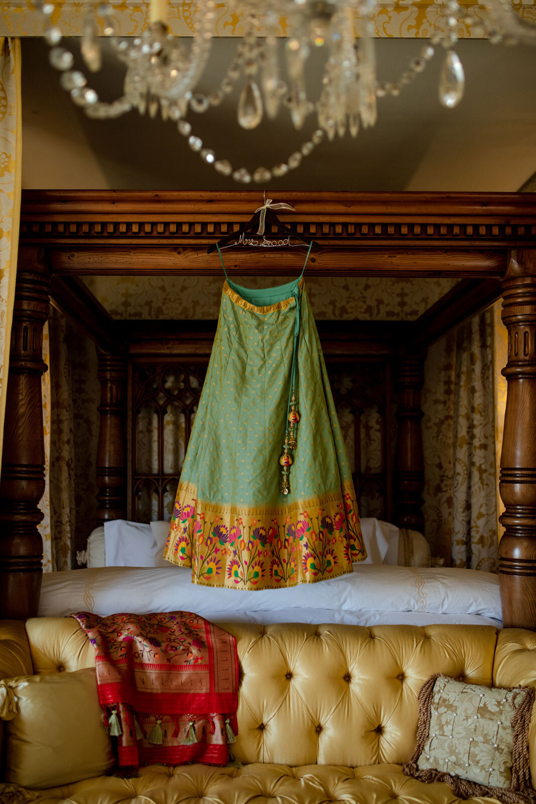 Traditional indian wedding dress hanging over bed at Dover Hall Richmond Virginia Carly Romeo