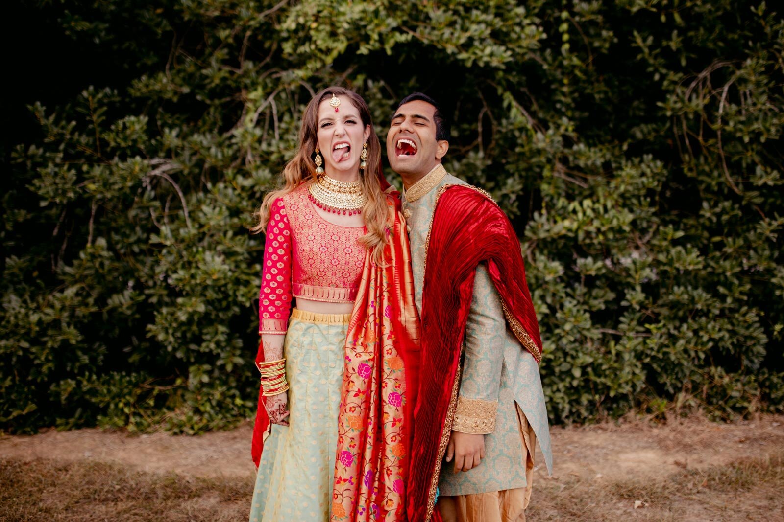 Couple making silly faces in traditional indian wedding attire at Dover Hall Richmond VA Carly Romeo + Co.