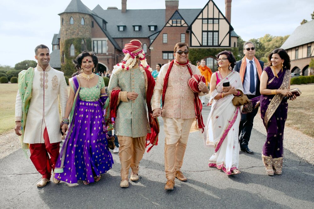 Indian groom with family walking to Baraat ceremony at Dover Hall Richmond VA Carly Romeo + Co.