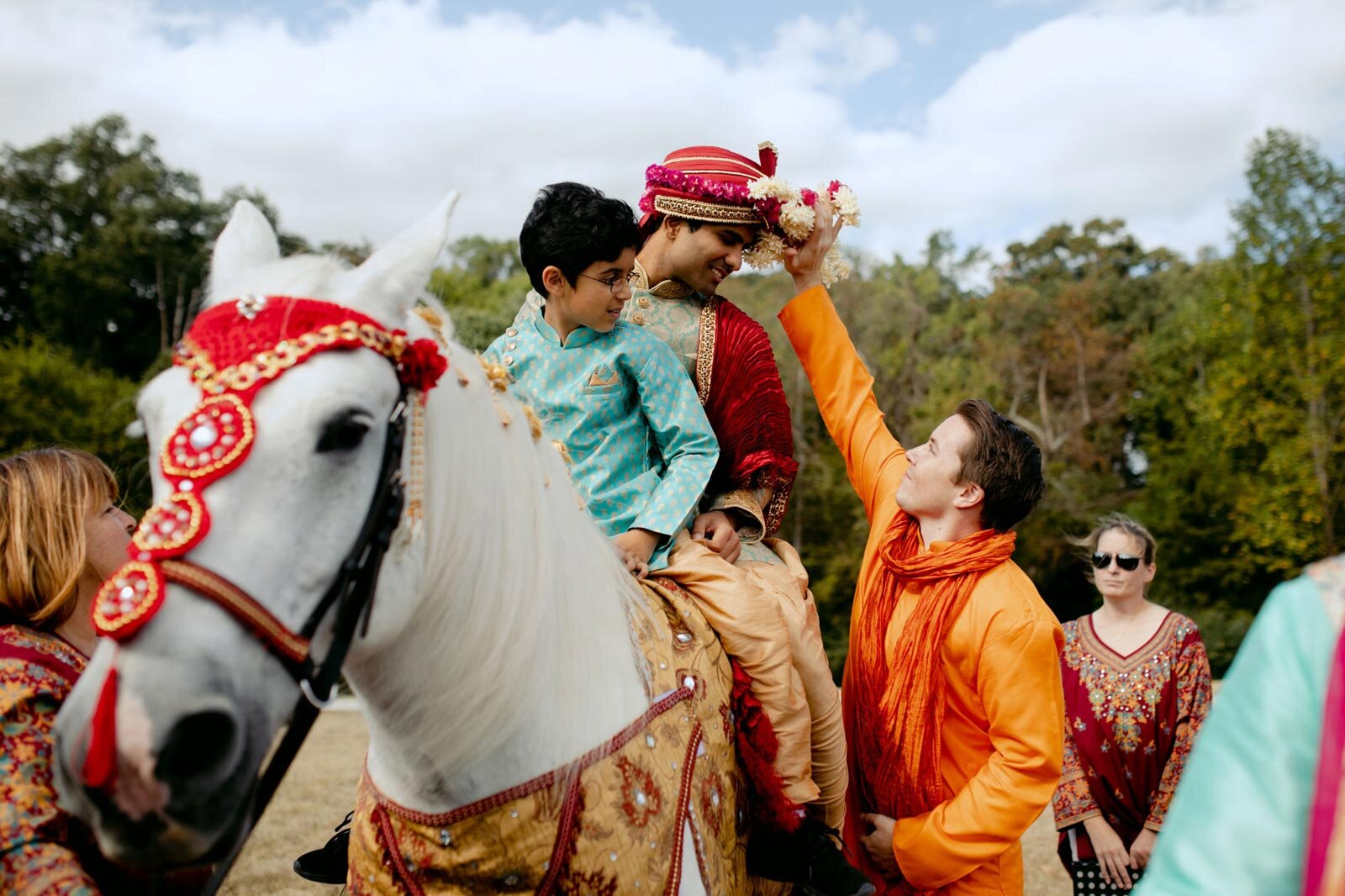 Indian groom  and boy riding horse in Baraat ceremony at Dover Hall Richmond VA Carly Romeo