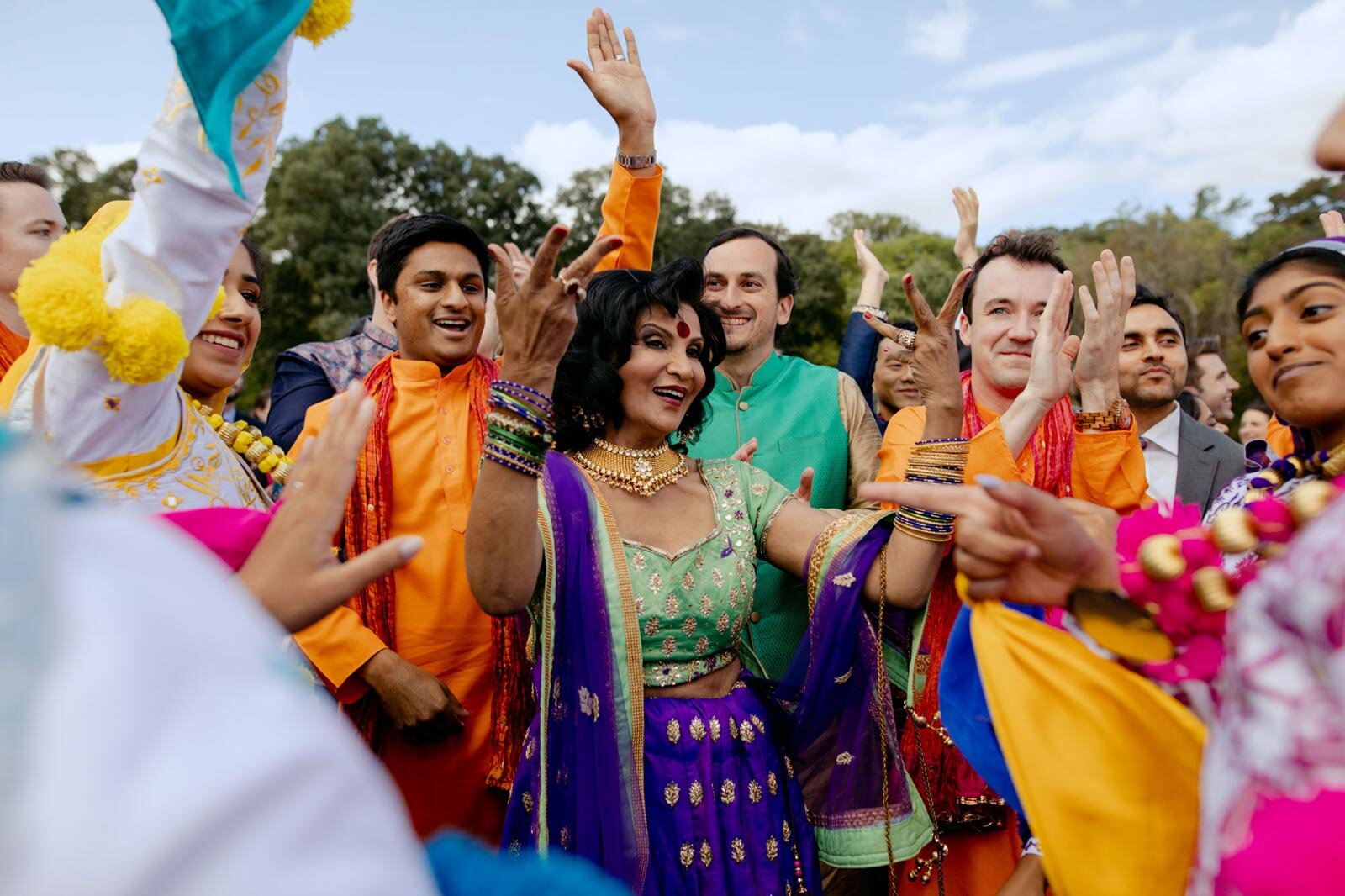 Indian mother of the groom dancing with guests at Baraat ceremony Dover Hall RVA Carly Romeo