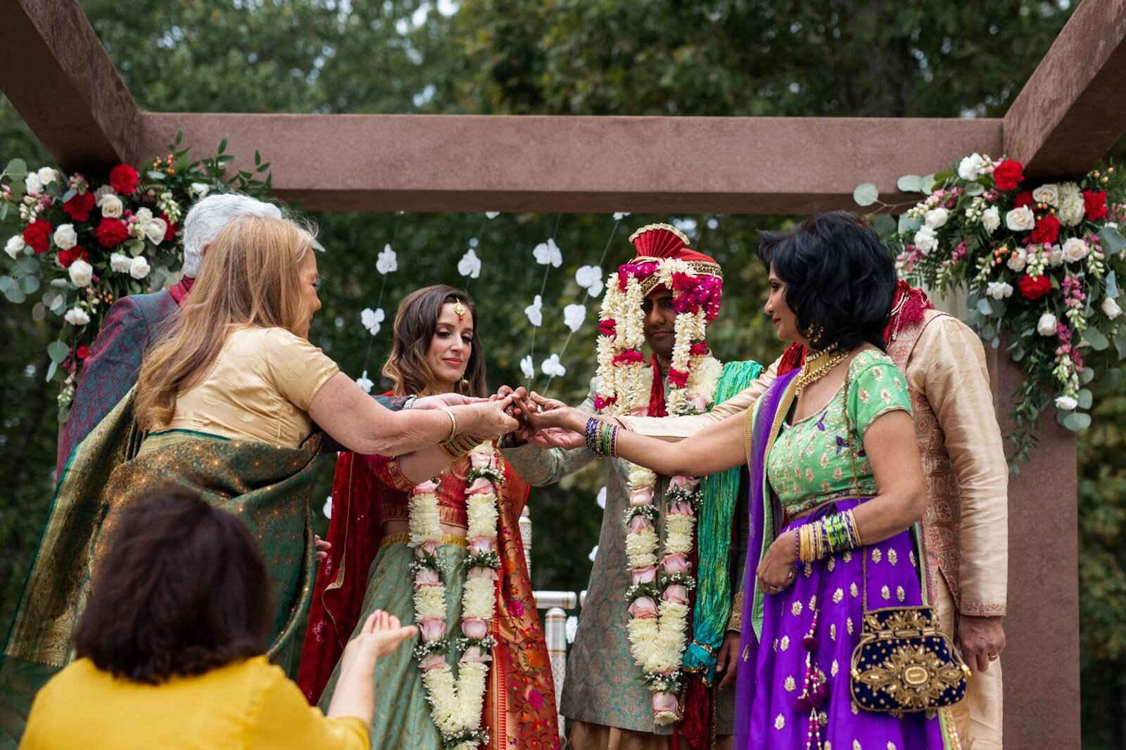Mixed race bride and groom with parents during tradition indian wedding ceremony at Dover Hall RVA Carly Romeo