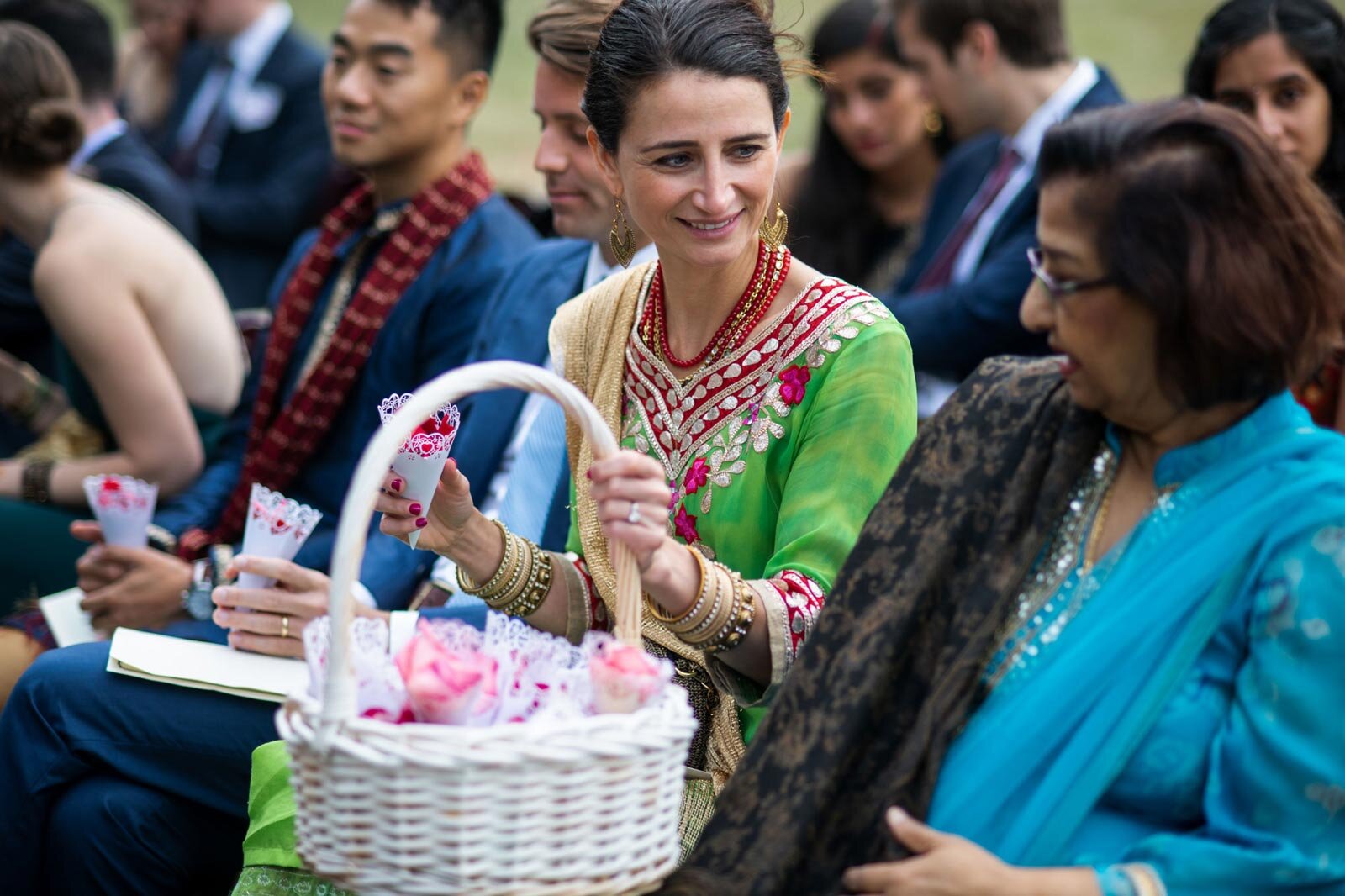 Guest passing cones of flower petals at Indian wedding at Dover Hall Richmond VA Carly Romeo + Co