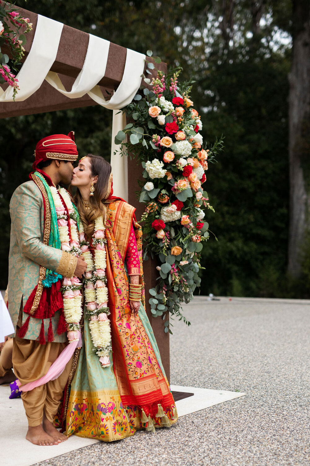 Mixed race couple kiss in mandap at traditional indian wedding ceremony at Dover Hall RVA Carly Romeo