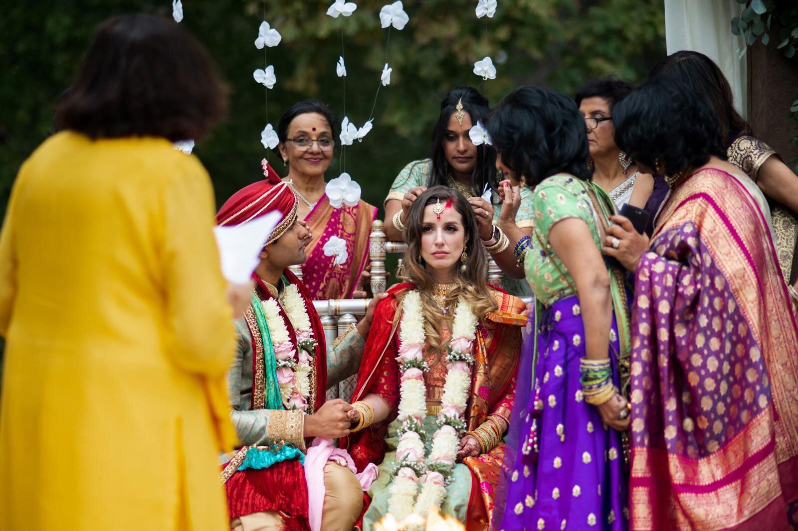 Bride surrounded by indian family during wedding ceremony at Dover Hall Richmond Carly Romeo &amp; Co.