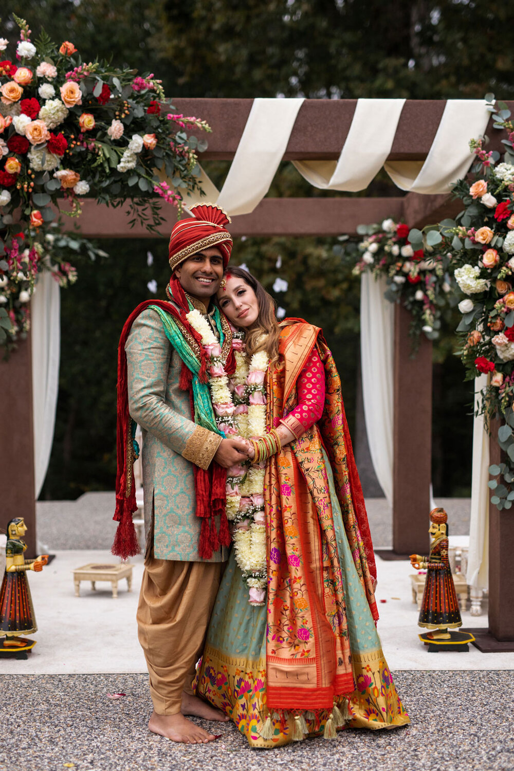 Newlywed multicultural couple by mandap wedding altar at Dover Hall RVA Carly Romeo photography