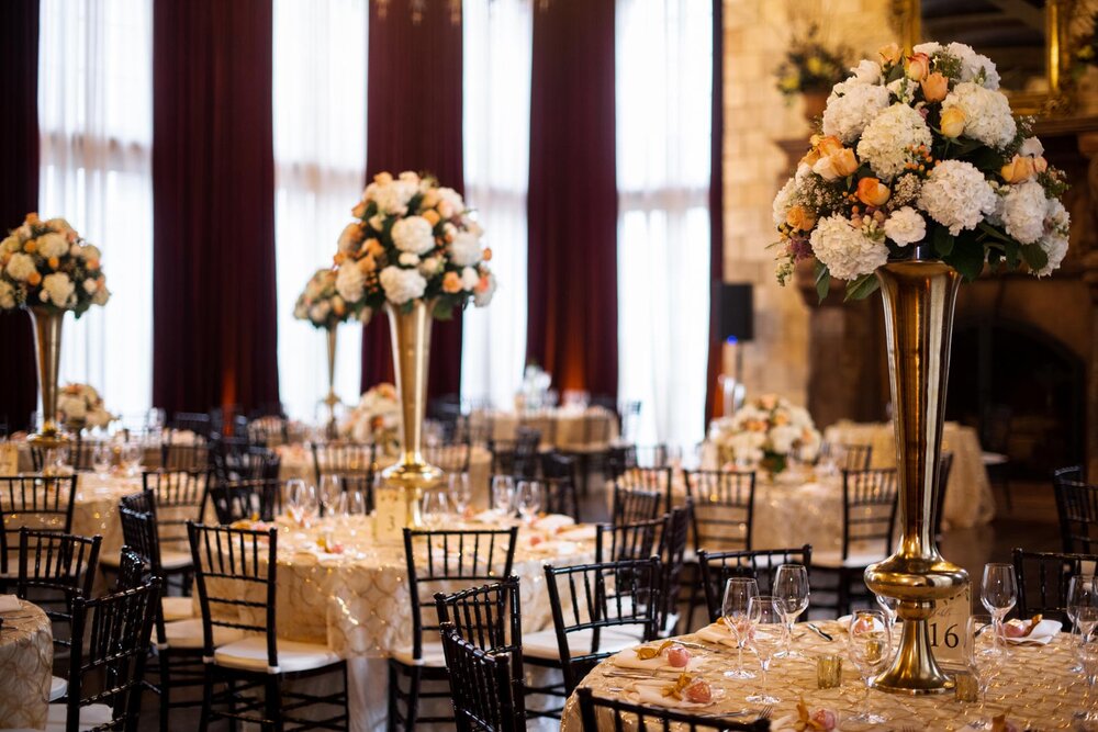 Large floral center pieces on tables set for wedding reception at Dover Hall Richmond VA Carly Romeo