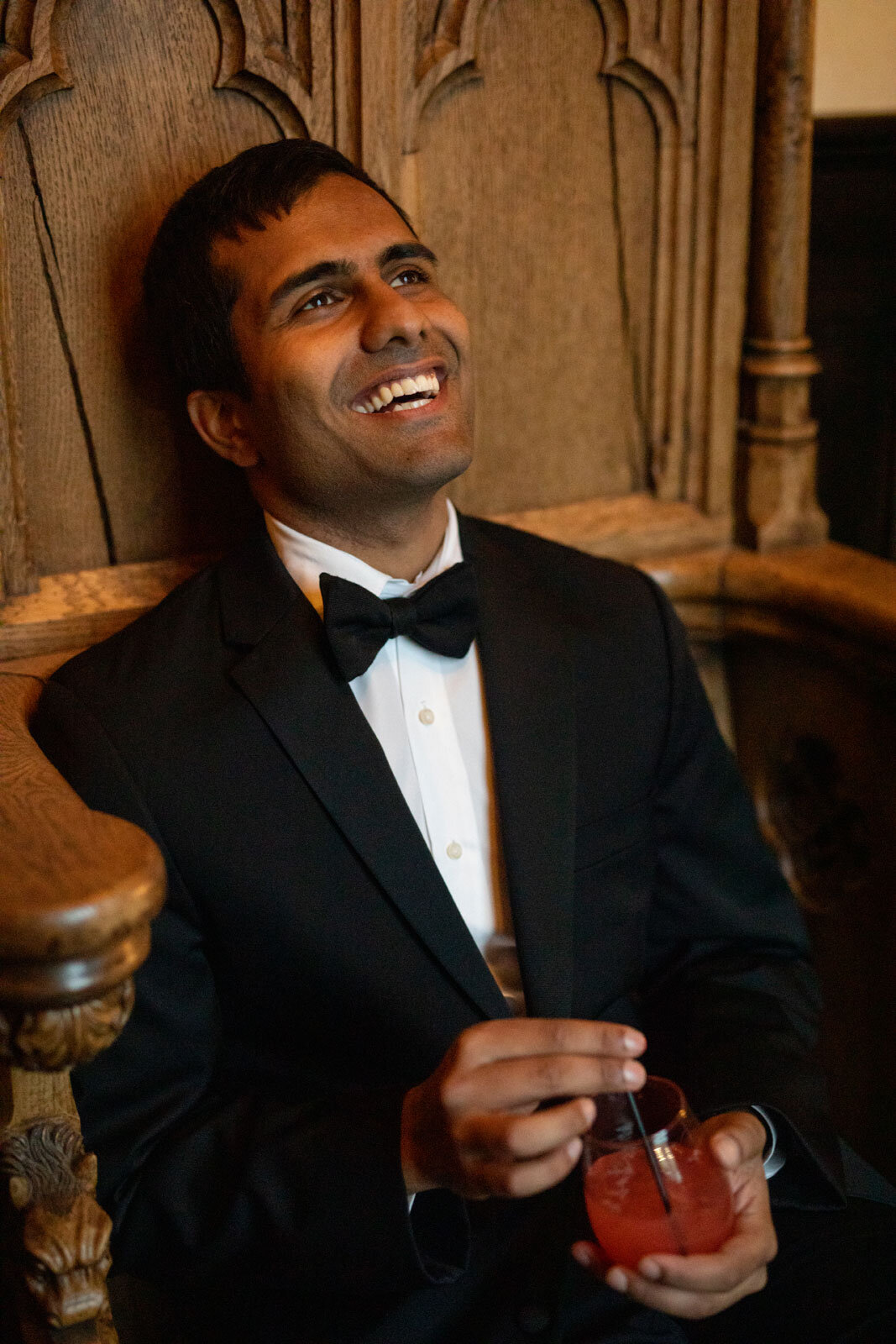 Indian groom smiling with drink at Dover Hall Richmond VA Carly Romeo photography