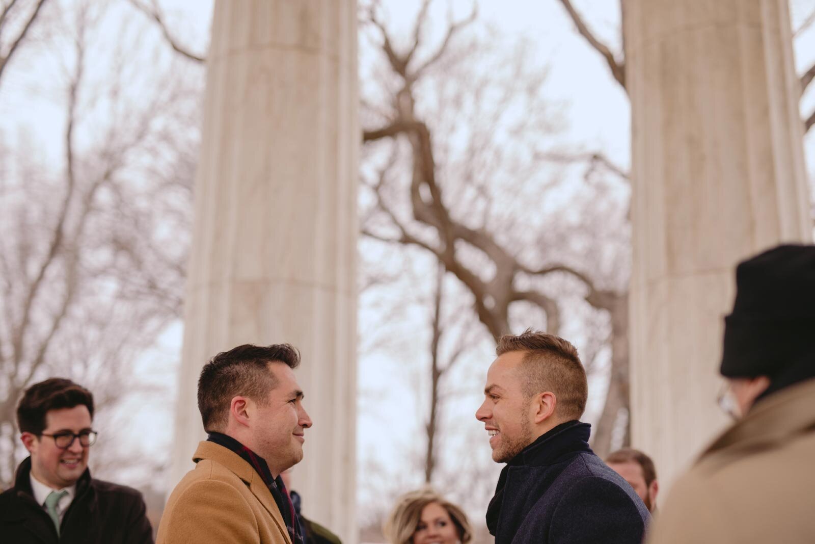 Gay couple smiling at each other under the Washington DC War Memorial Carly Romeo photography