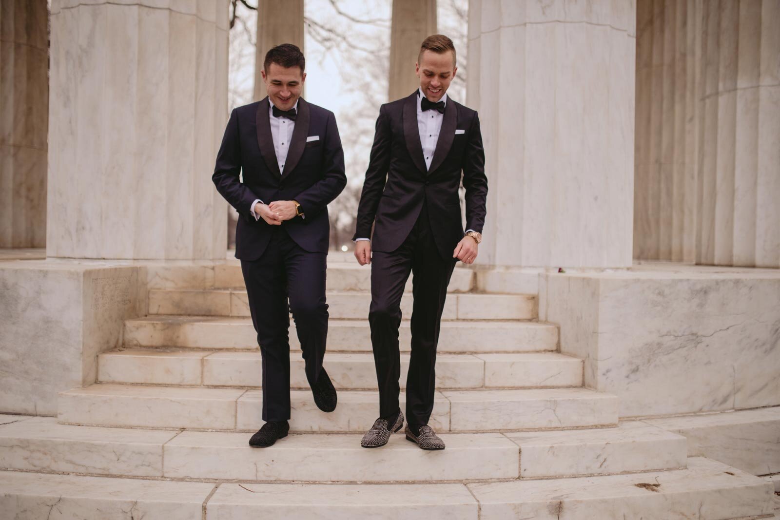 Newlywed gay couple walking down steps at Washington DC War Memorial Carly Romeo
