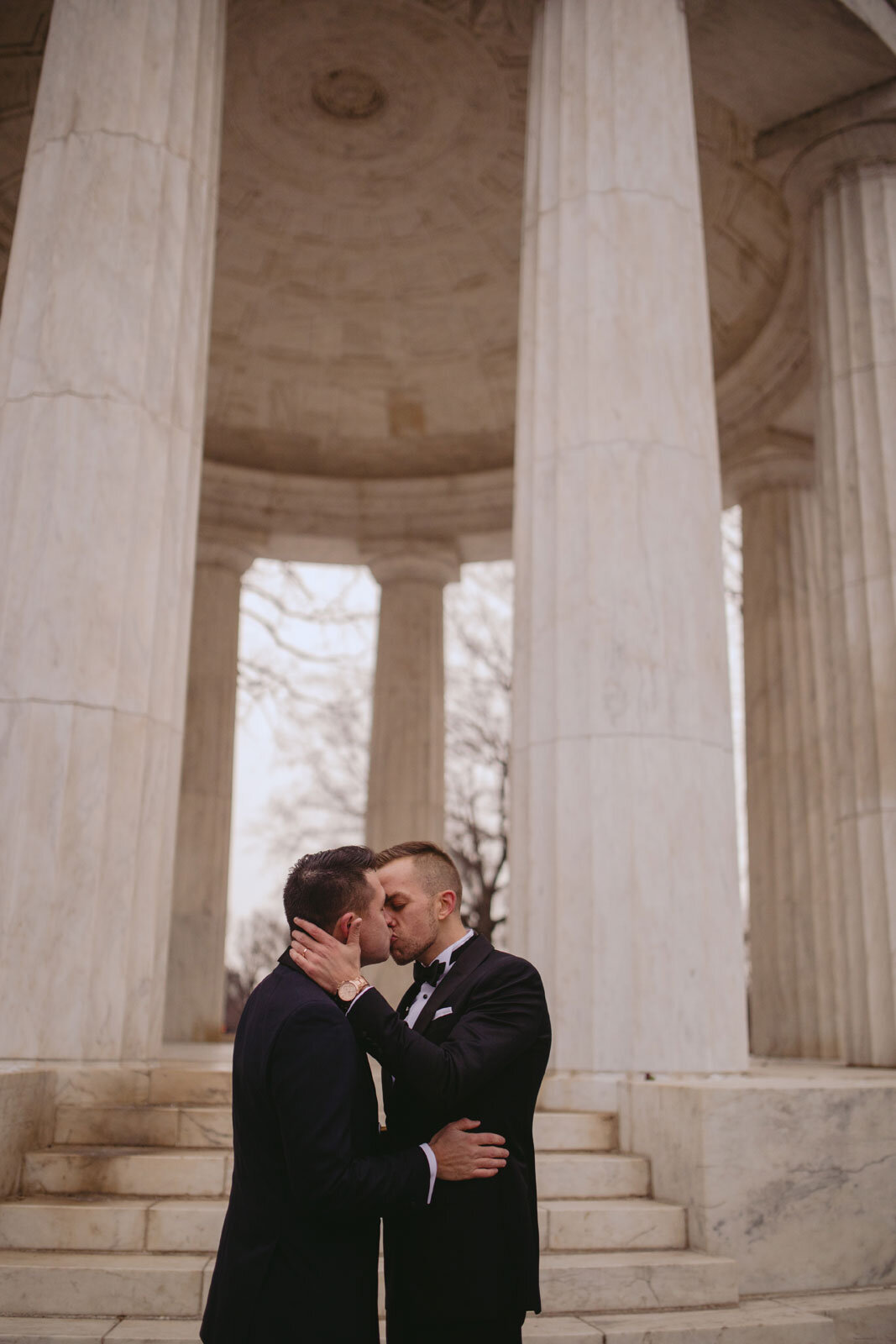 Newlywed gay couple kissing at Washington DC War Memorial Carly Romeo wedding photography