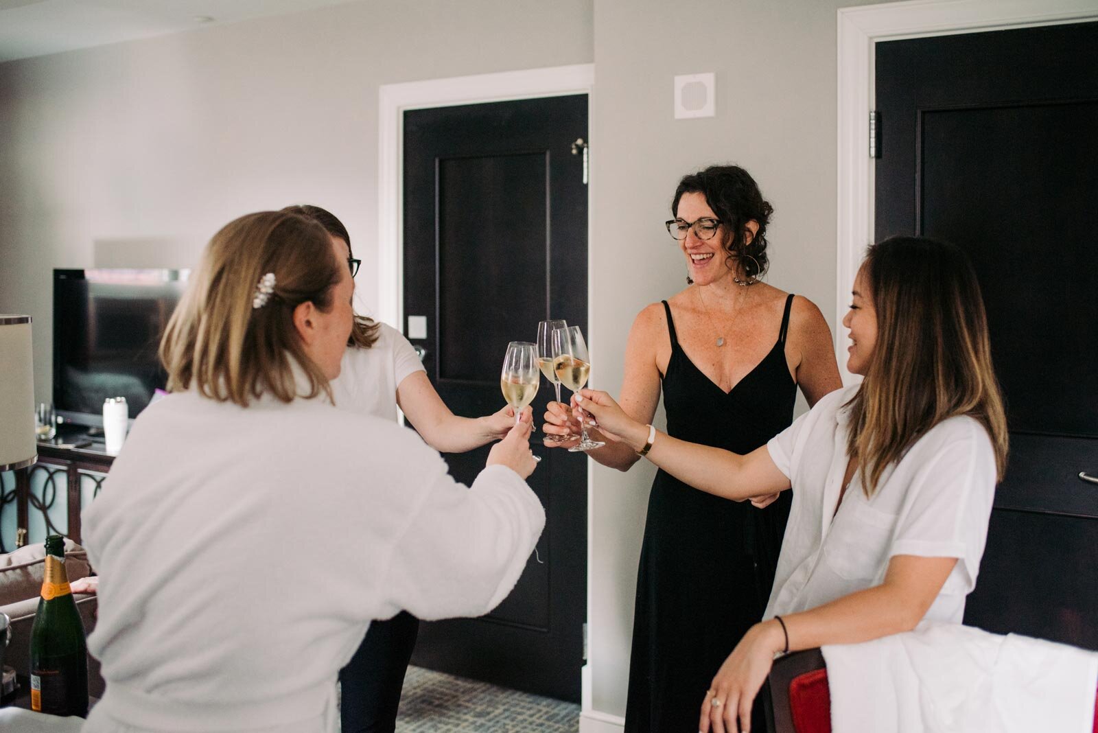 Bridal Party clinking glasses of champagne in Pittsburgh PA Carly Romeo wedding photography