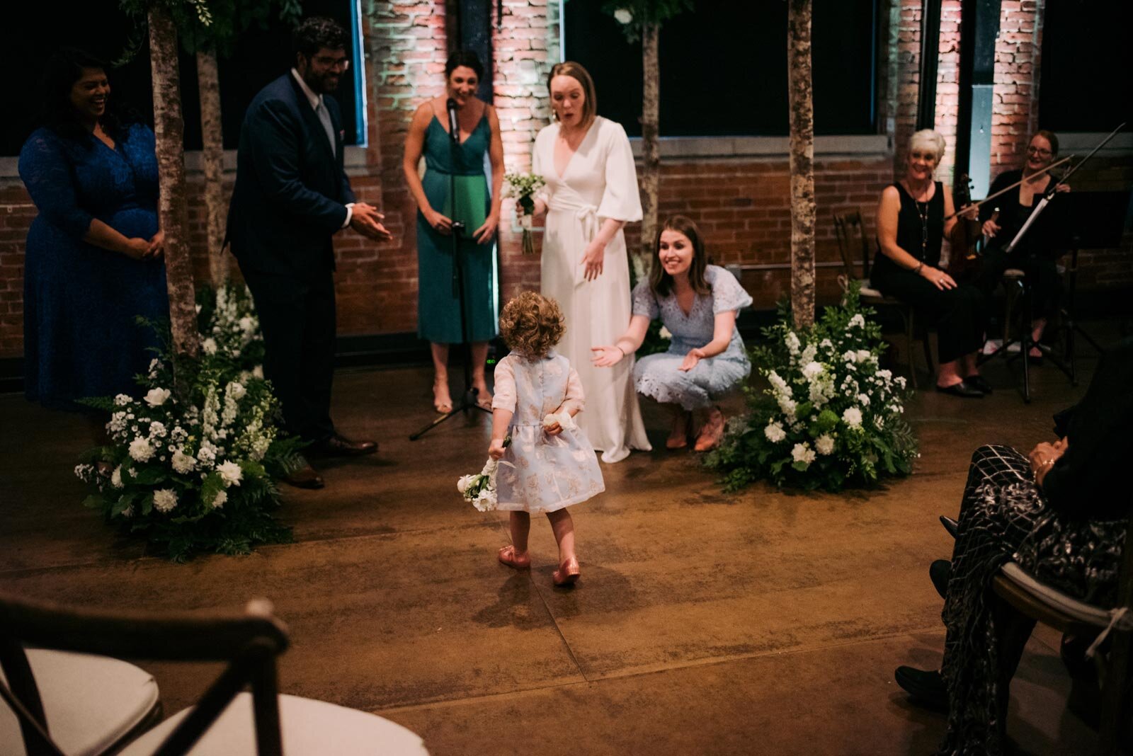 Flower girl walking down isle towards altar in Pittsburgh Opera House PA Carly Romeo and Co.