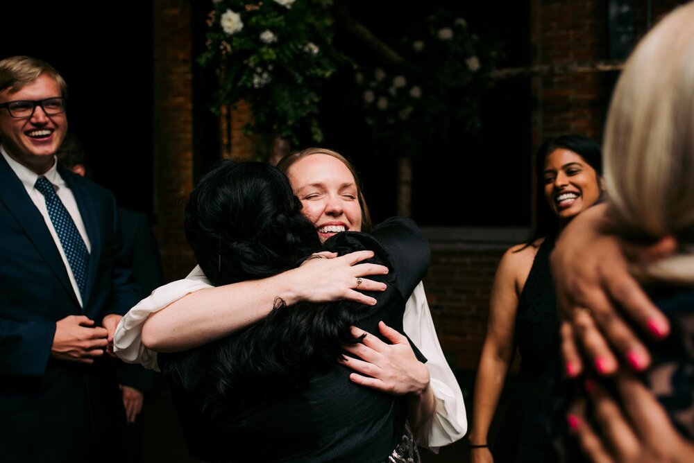 Bride hugging guests after wedding ceremony at Pittsburgh Opera Pennsylvania Carly Romeo