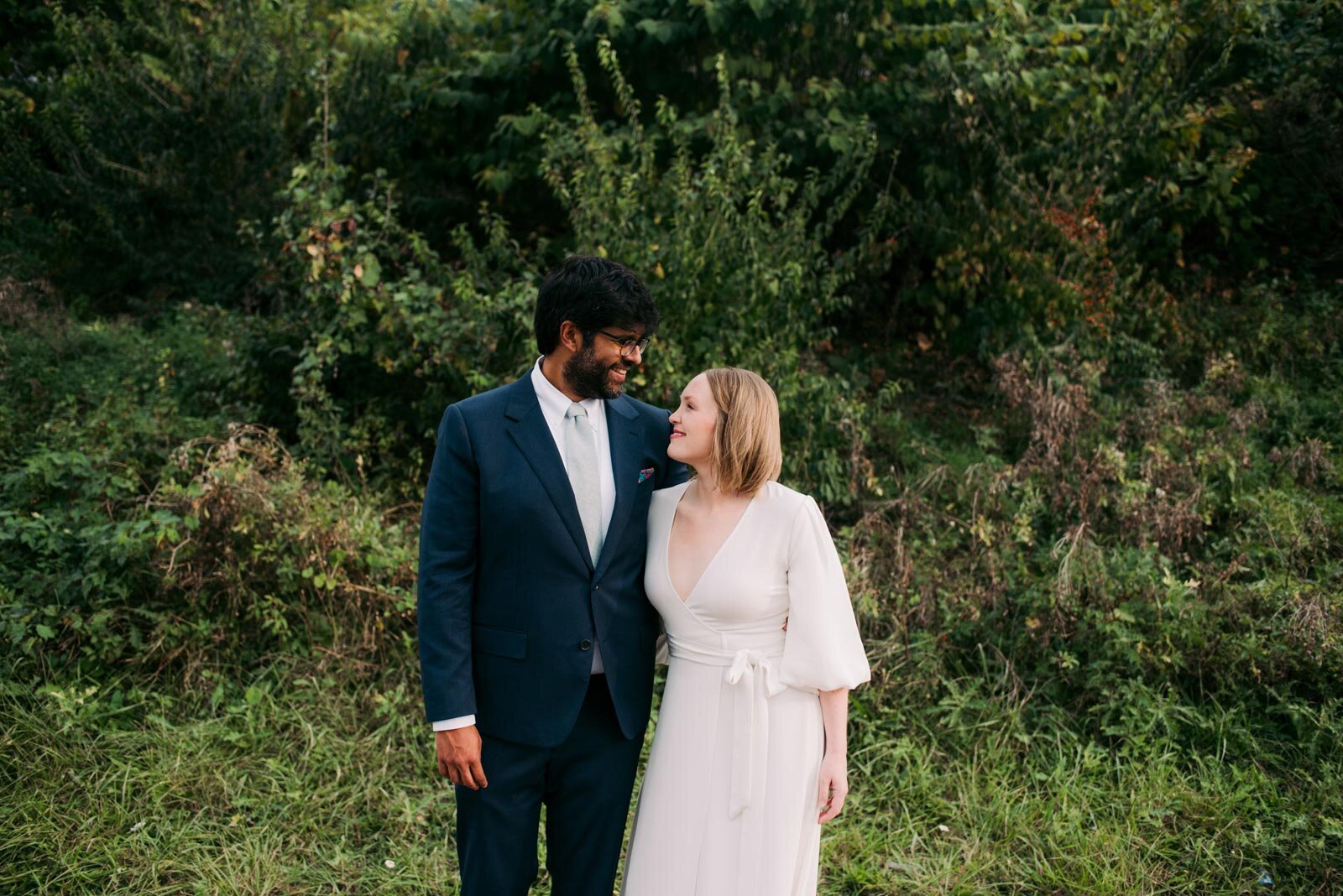 Newlywed Couple smiling together before lush greenery in Pittsburgh PA Carly Romeo &amp; Co.