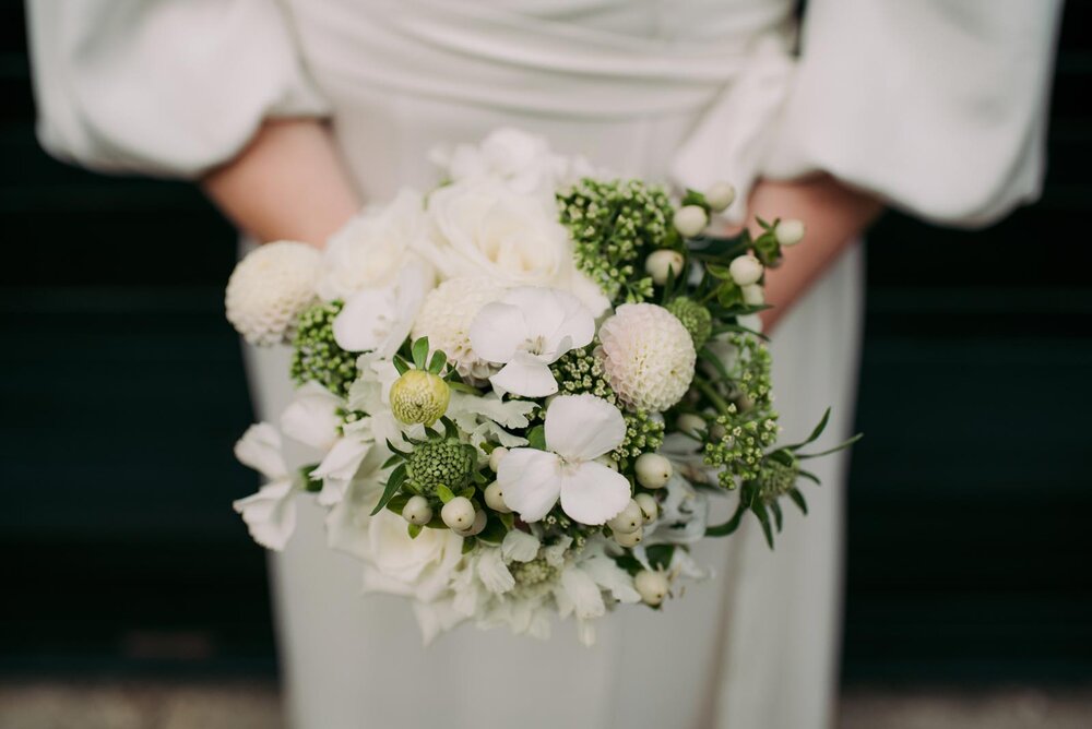Bride holding green and white bouquet in Pittsburgh PA Carly Romeo wedding photography