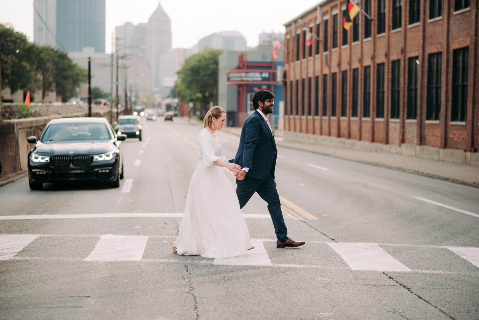 Newlywed couple walking crosswalk in Pittsburgh Pennsylvania Carly Romeo and Co.