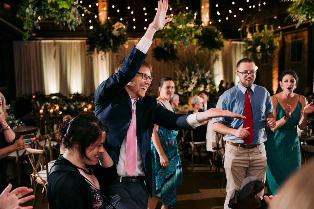 Man dancing with out stretched hands at wedding reception in Pittsburgh Opera PA Carly Romeo photography