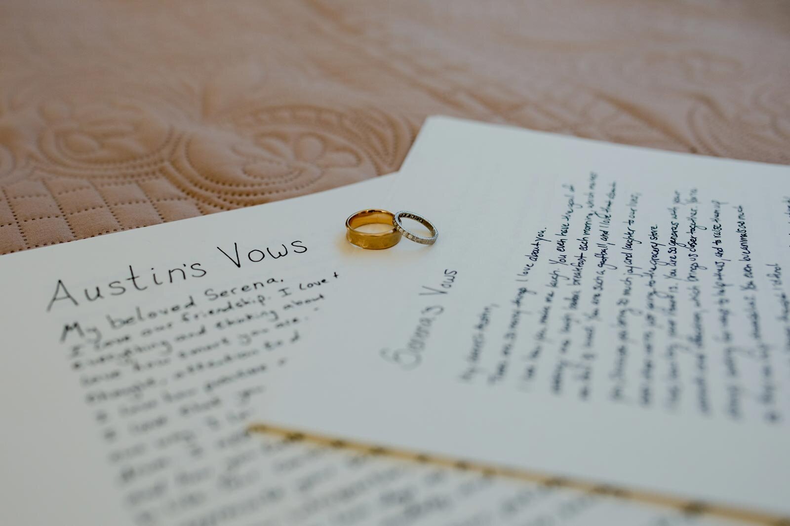 Two wedding rings resting on hand written vows in Mendocino CA Carly Romeo Photography
