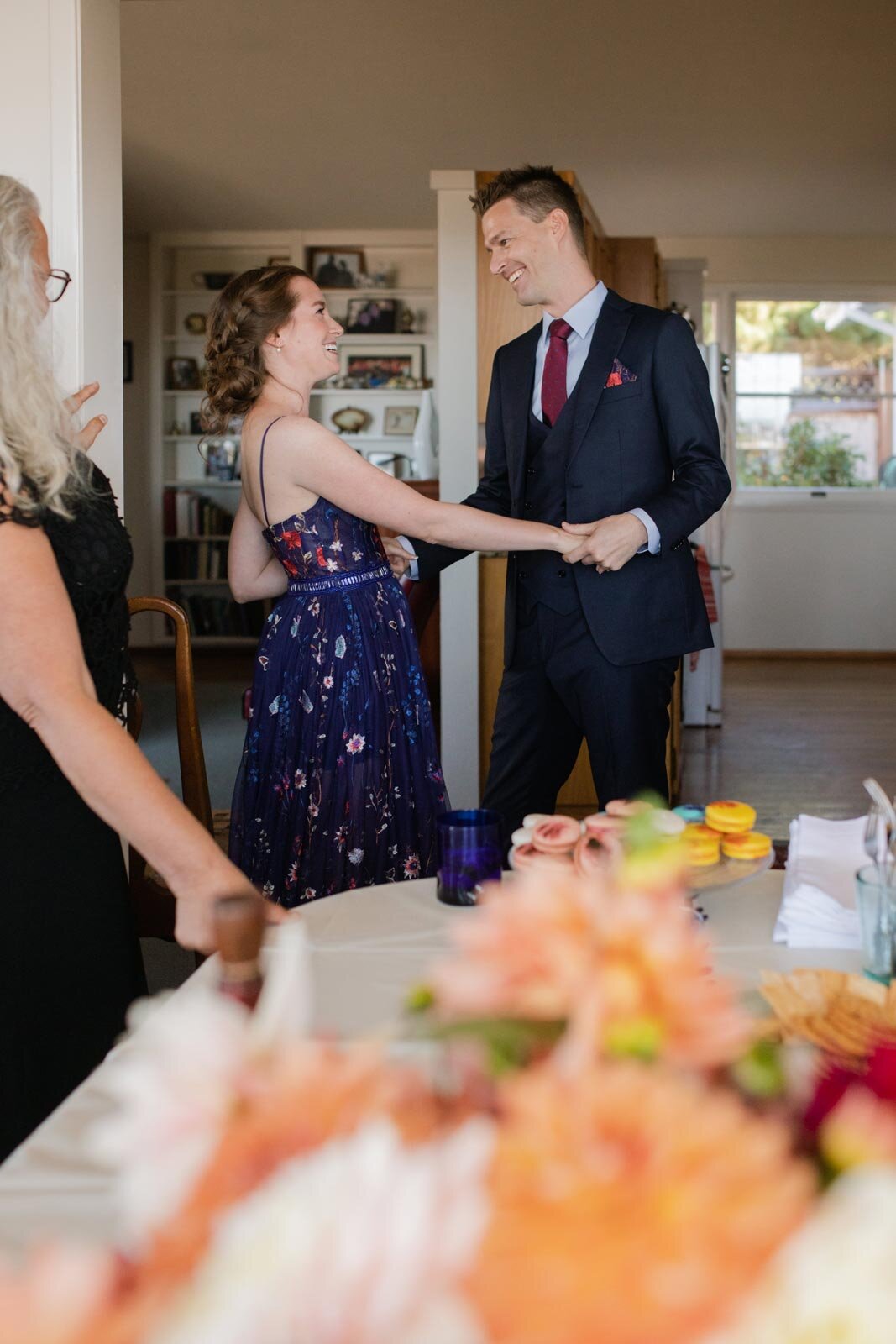 Bride and groom holding both hands and smiling together in Mendocino CA Carly Romeo wedding photography