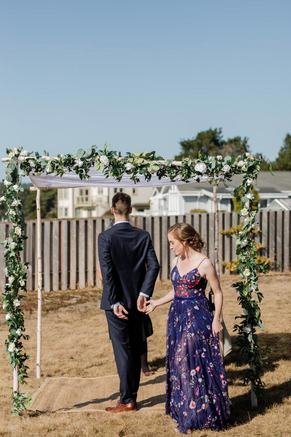 Bride walking around the groom under backyard chuppah in Mendocino CA Carly Romeo + Co.