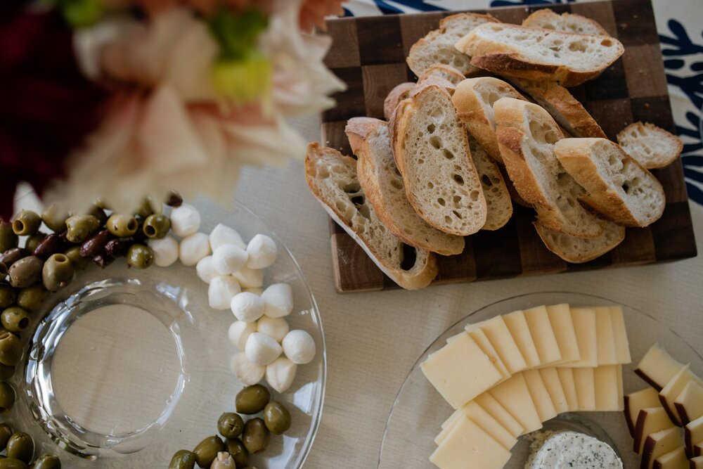 Appetizer spread of sliced cheese and break with olives and mozzarella in Mendocino CA Carly Romeo and Co.