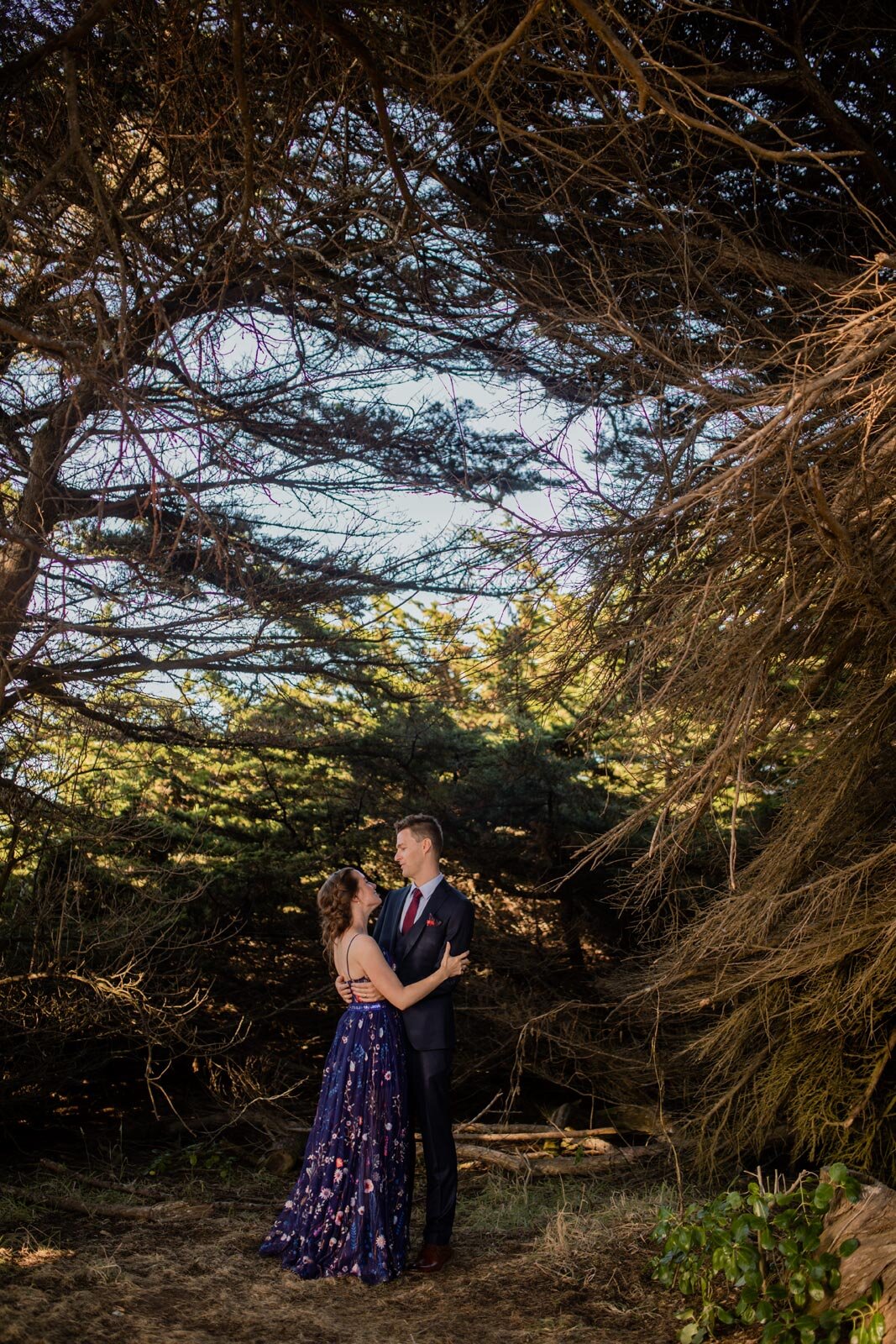 Bride and groom holding each other under thick woodland in Mendocino California Carly Romeo