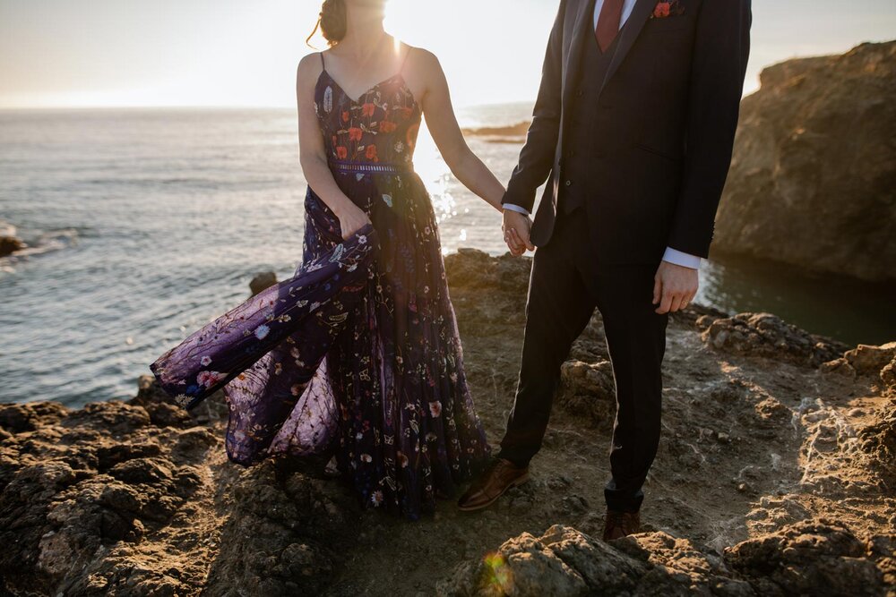 Groom and Bride in nontraditional blue embroidered dress on oceanside cliff in Mendocino CA Carly Romeo