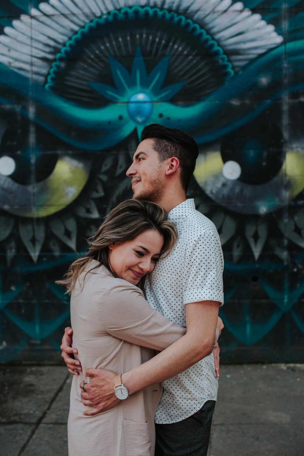 Man and woman embracing before a mural in Richmond VA Carly Romeo engagement photography (Copy)