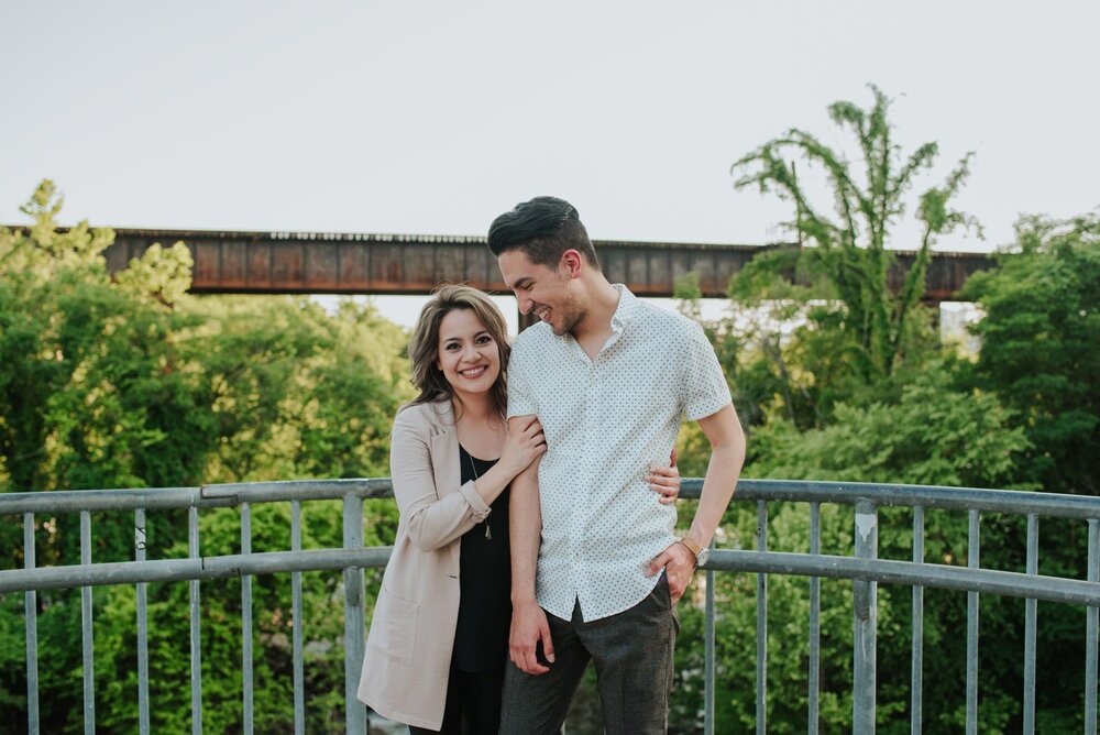 Woman smiling and holding partner's arm by a bridge in Richmond Virginia Carly Romeo + Co. (Copy)