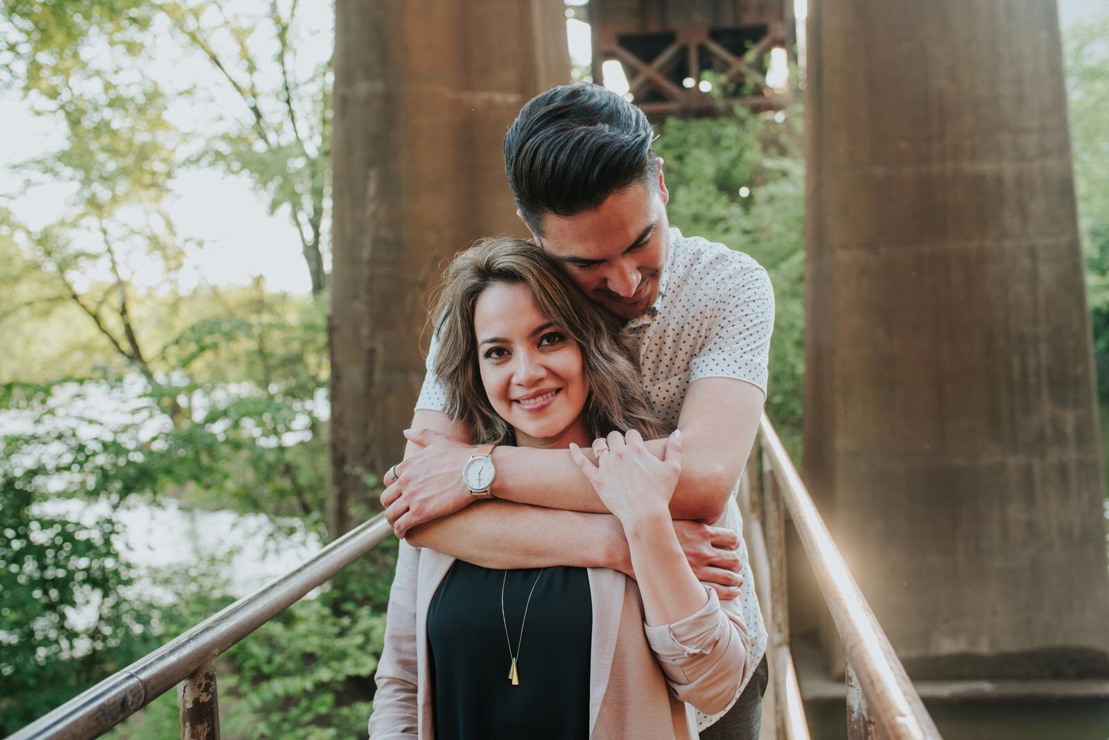 Man holding partner from behind on a bridge over the James River in Richmond VA Carly Romeo (Copy)