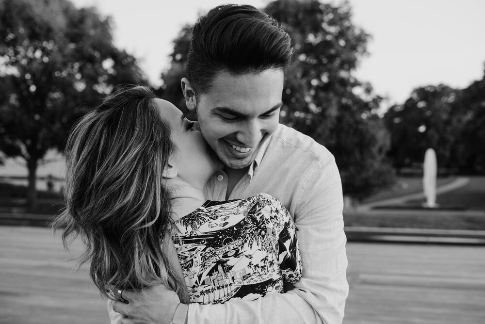 Woman kissing fiancé's neck in black and white in Richmond VA Carly Romeo wedding photography (Copy)