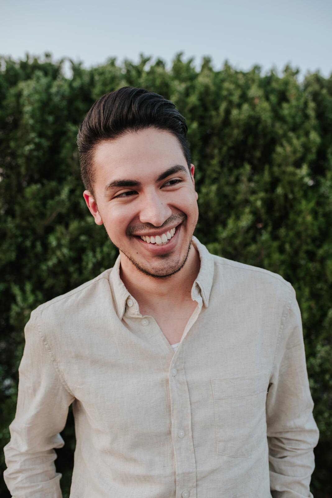 Latino fiance smiling before greenery in Richmond Virginia Carly Romeo photography (Copy)