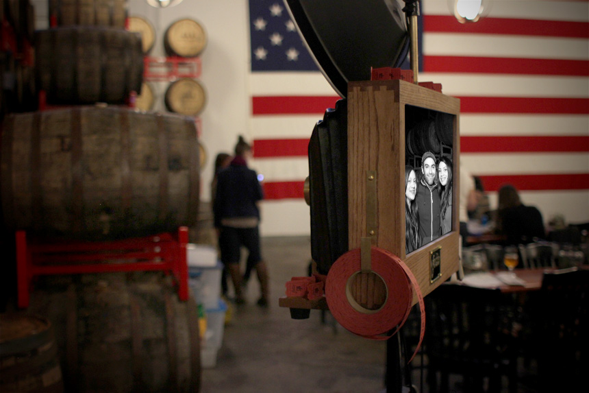 Fotio photo booth setup in the Kedzie Brewery and Tap Room at Revolution Brewery. The huge flag is so cool!